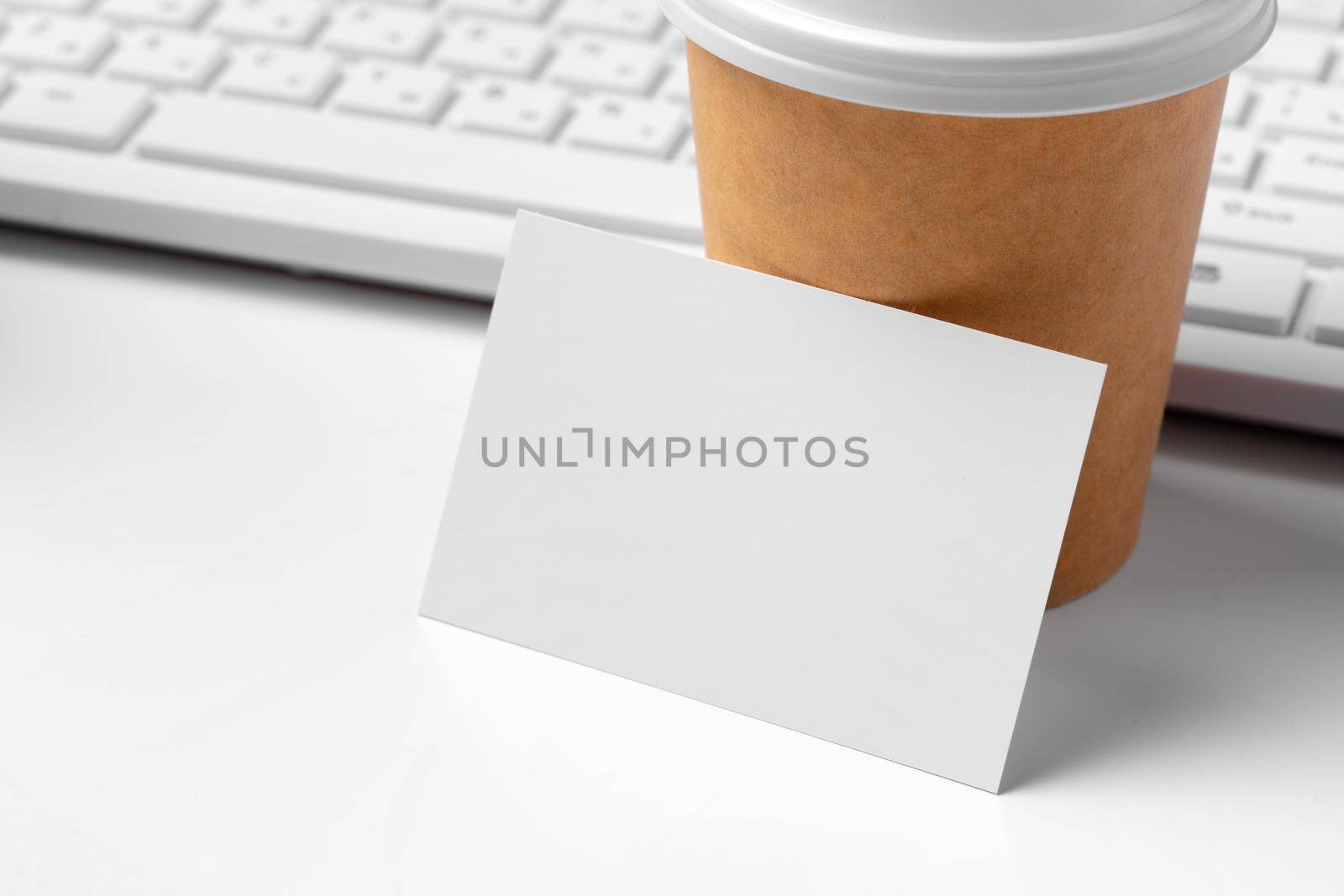 Blank business cards with supplies and keyboard on office table. by Fabrikasimf