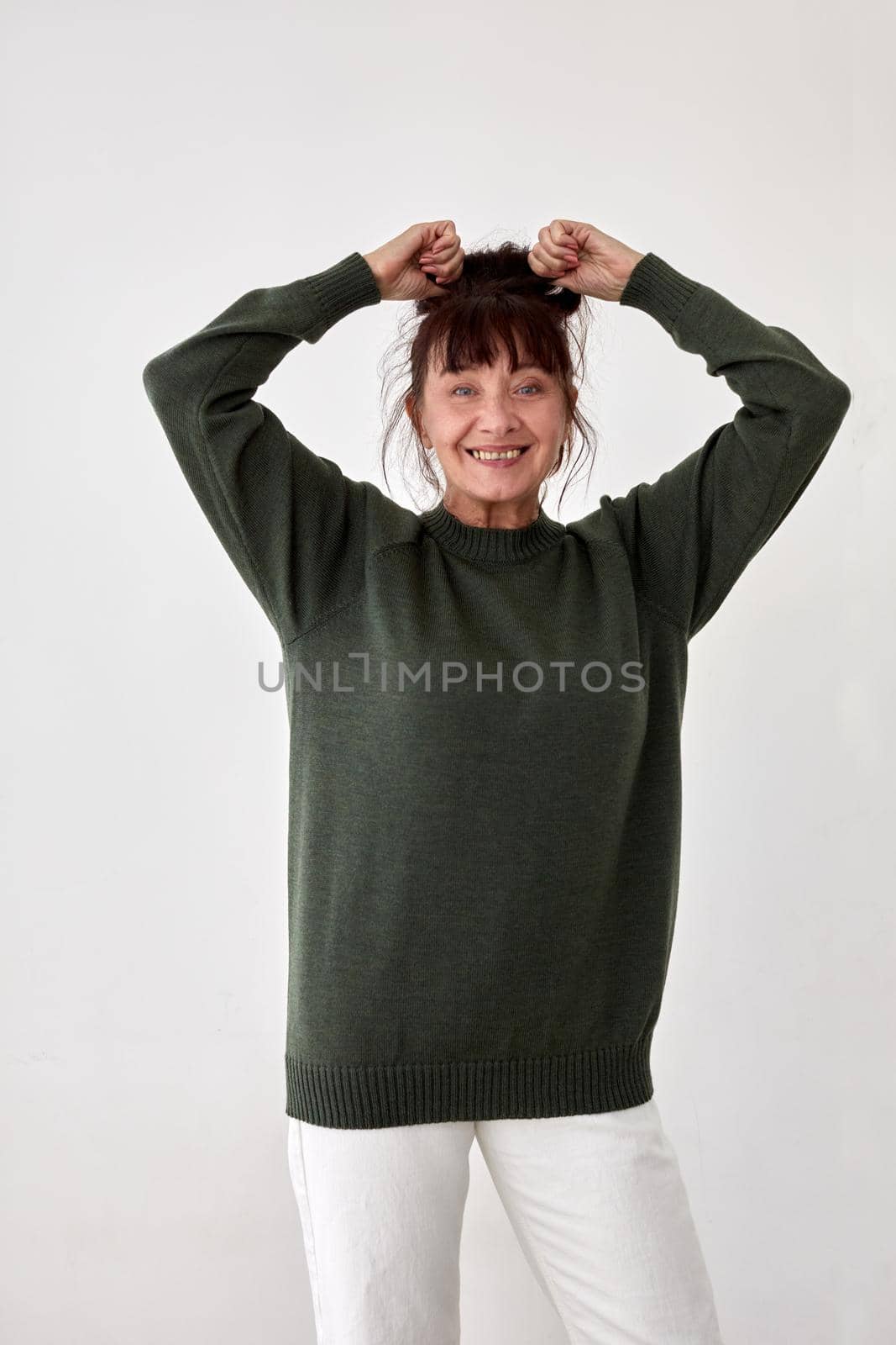 Happy mature woman in warm green sweater by Demkat