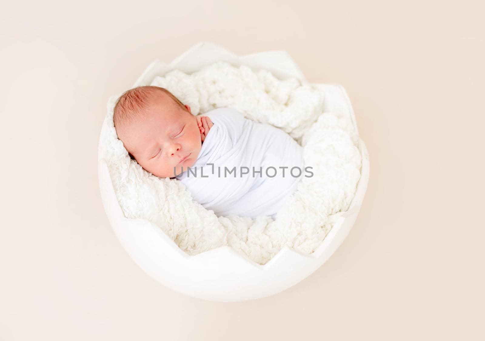 Peaceful neweborn sleeping in egg shaped cradle