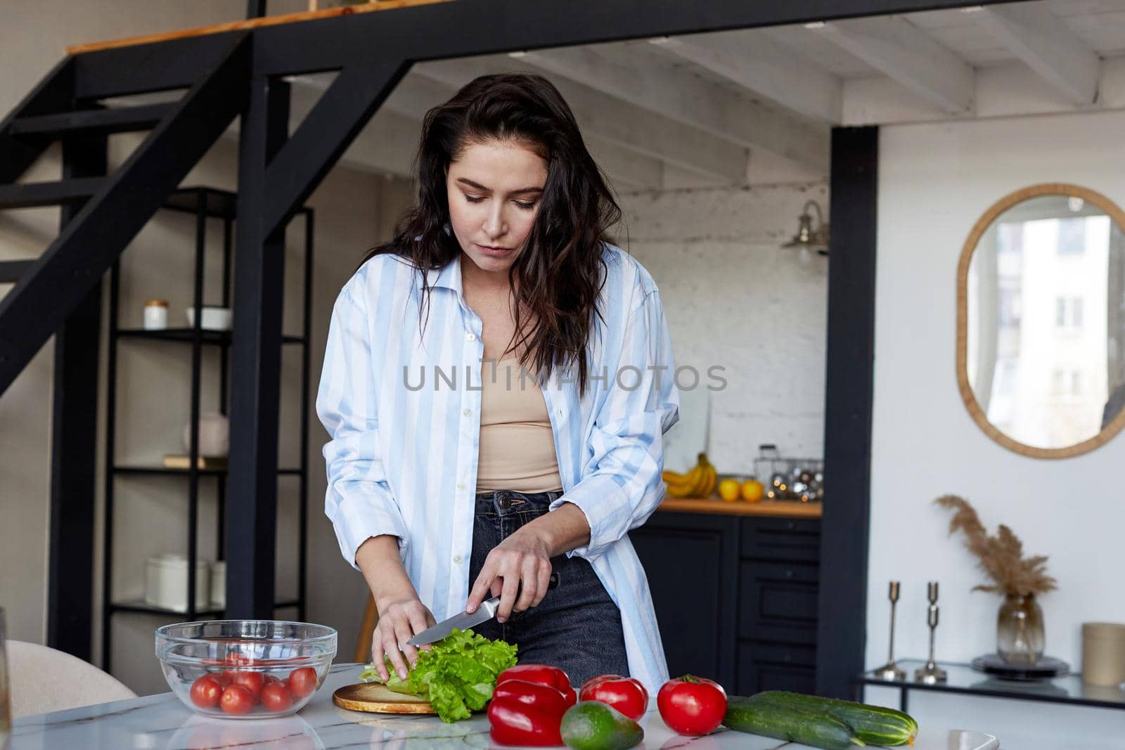 Brunette woman cooking in her cozy kitchen healthy food