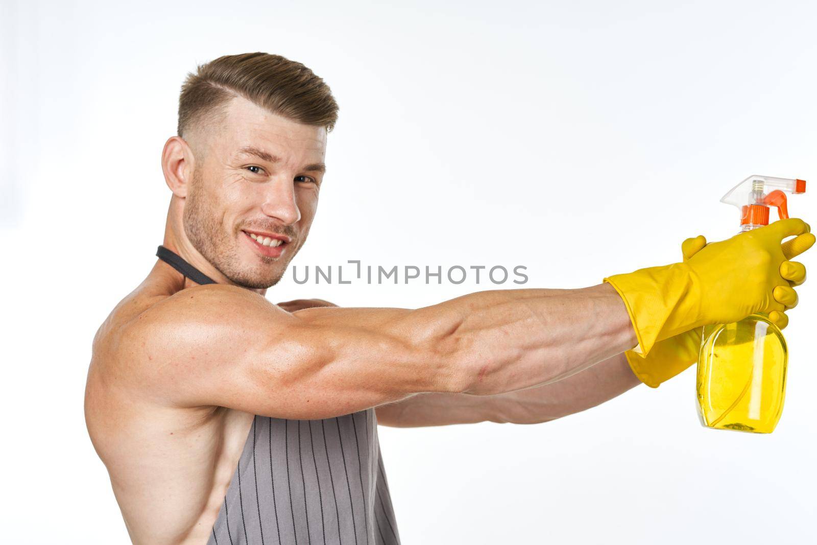 man wearing apron detergent cleaning posing service by Vichizh
