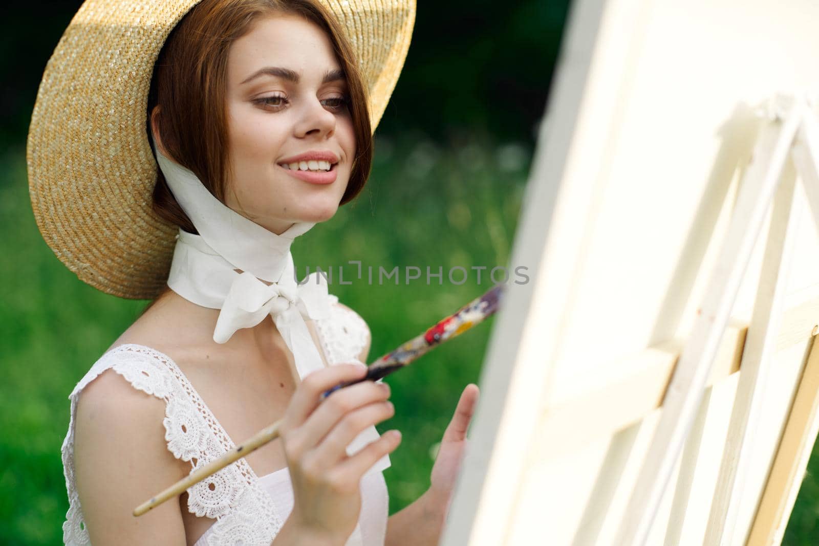 woman artist paints a picture outdoors easel creative by Vichizh