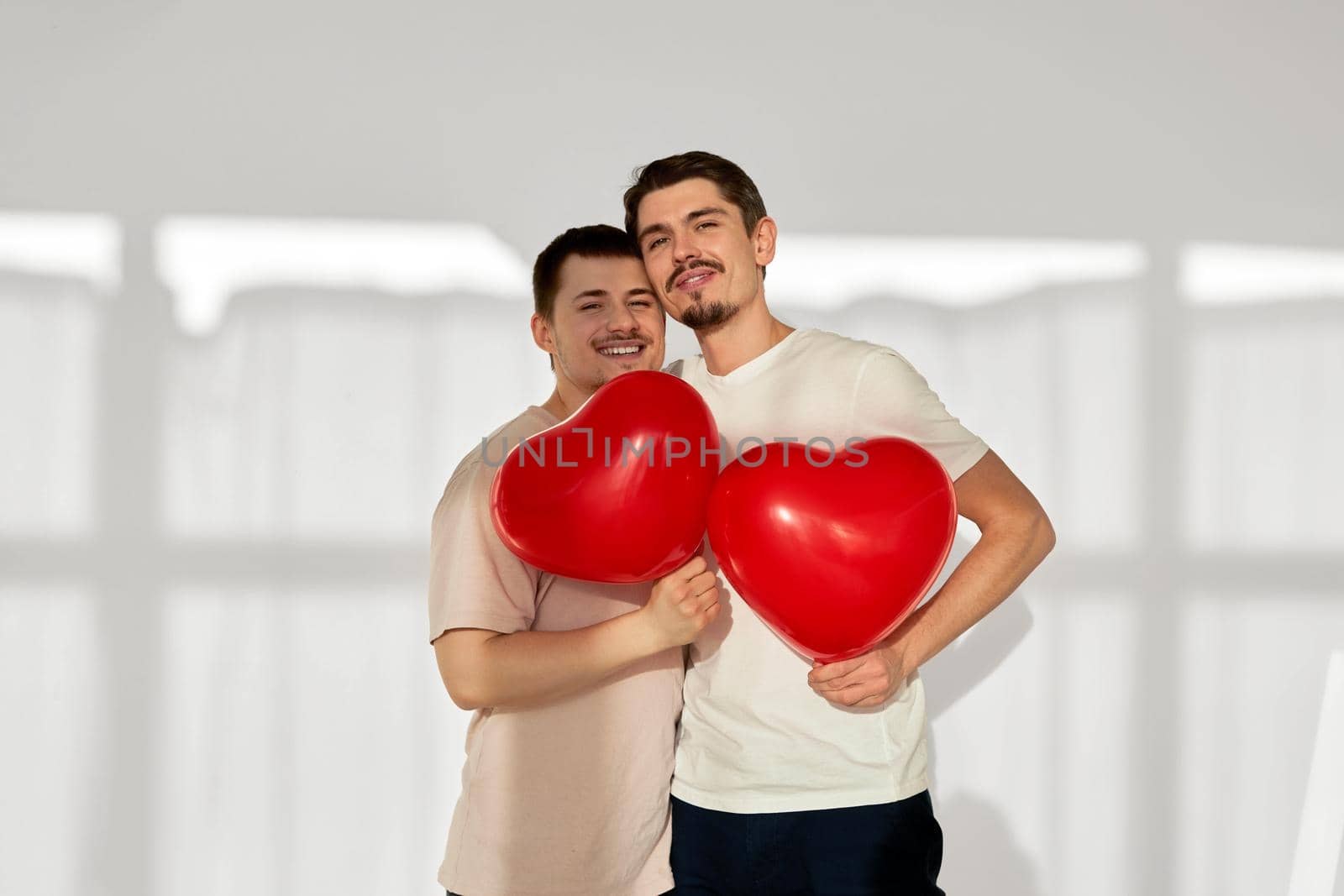 Gay couple of men with balloons in the shape of hearts by Demkat