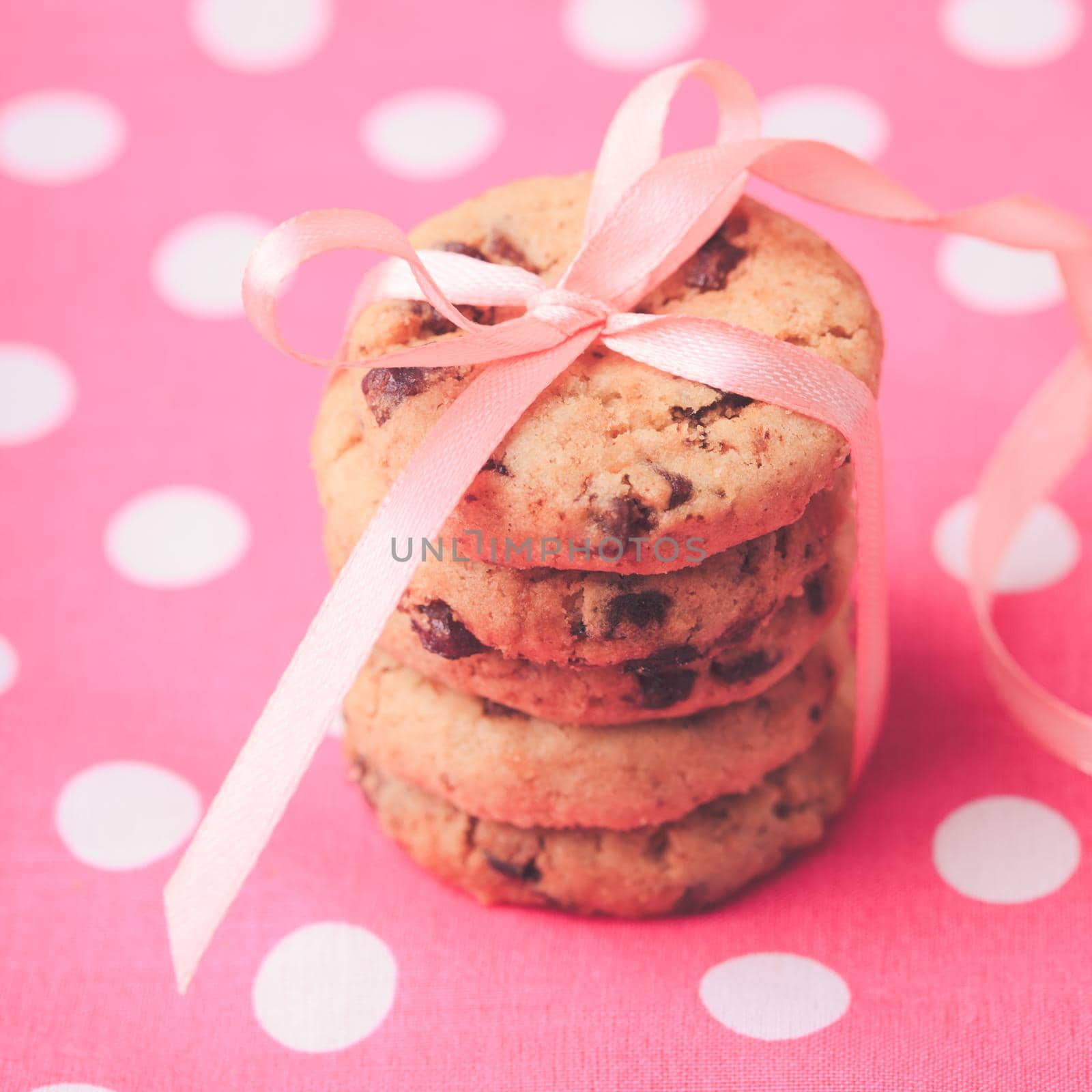Cookies with ribbon. Holiday present on pink polka dot textile