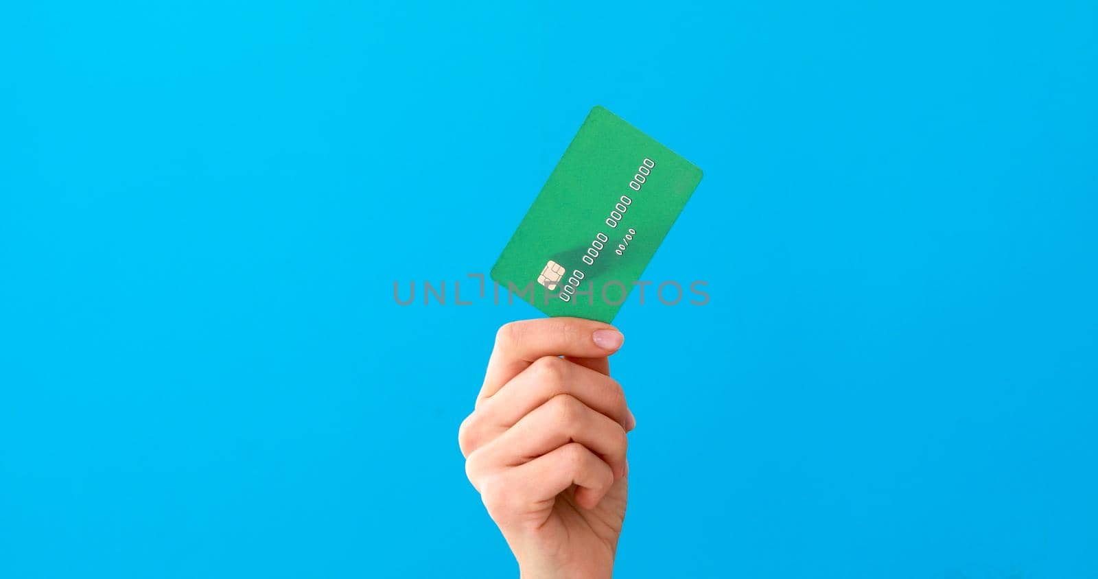 Hand holding mockup credit cards and showing on the blue background