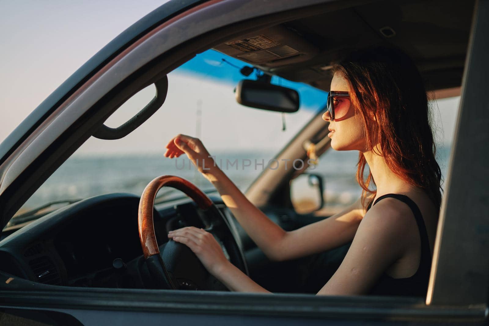 pretty woman in sunglasses driving a car trip by Vichizh