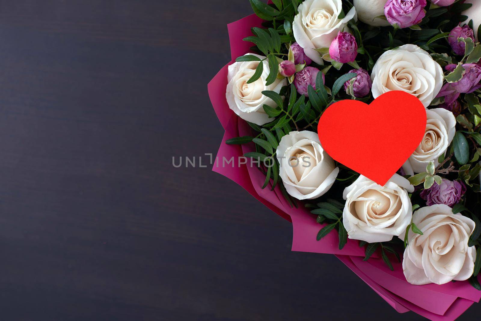 Valentines day greeting card with rose flowers bouquet dark background with space for your greetings. Top view flat lay