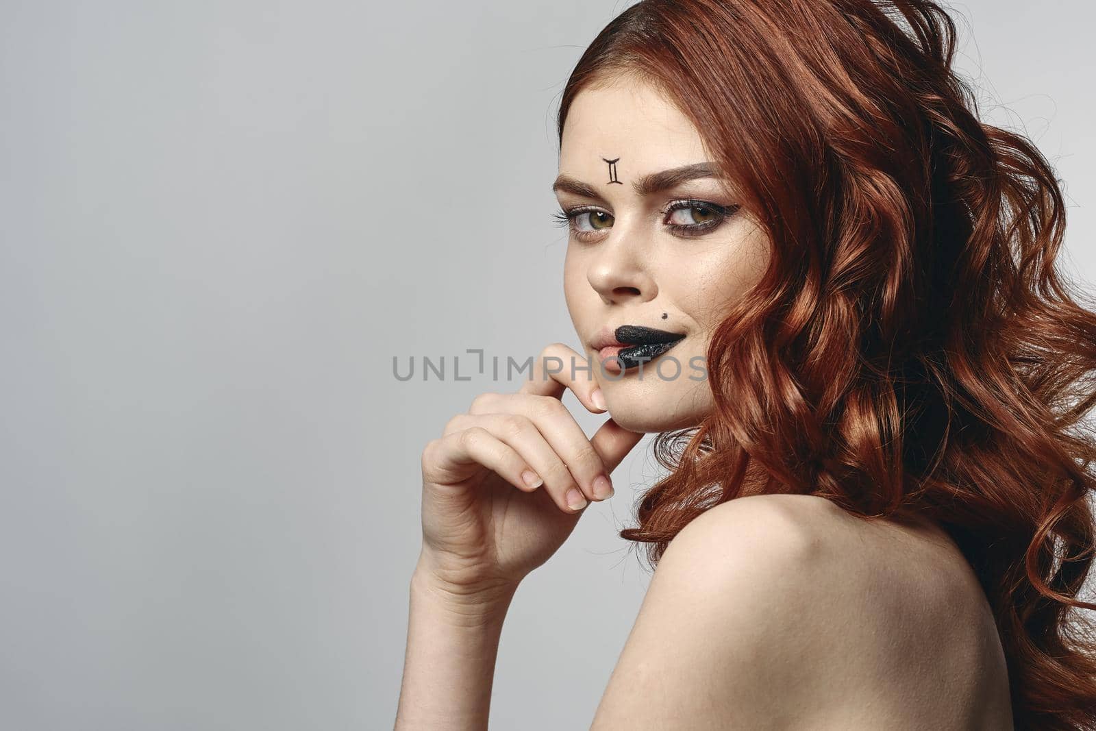 red-haired woman with bare shoulders bright makeup base zodiac sign horoscope. High quality photo