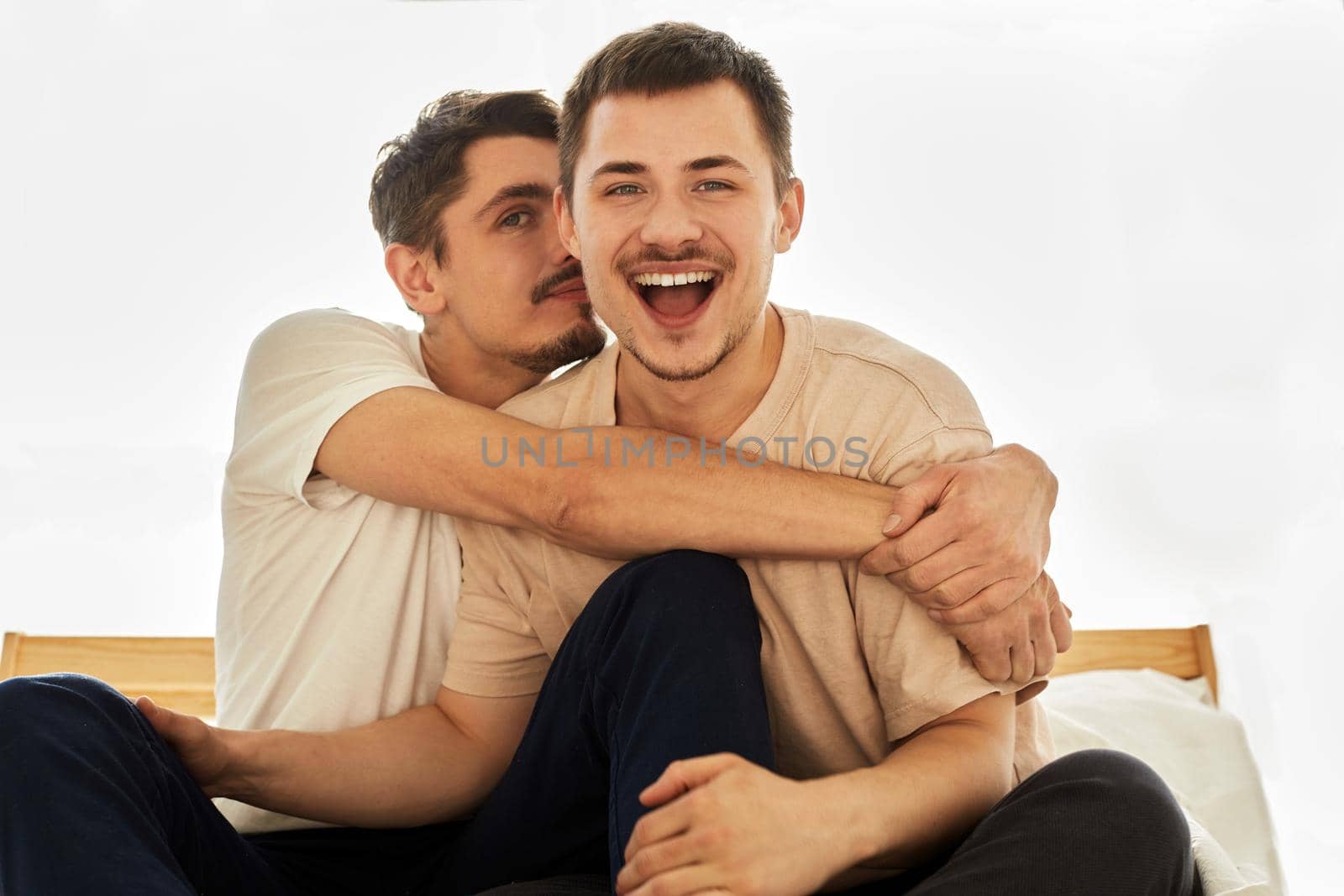 Portrait cute Male Queer Couple at Home siting on a sofa and Look at the Camera by Demkat