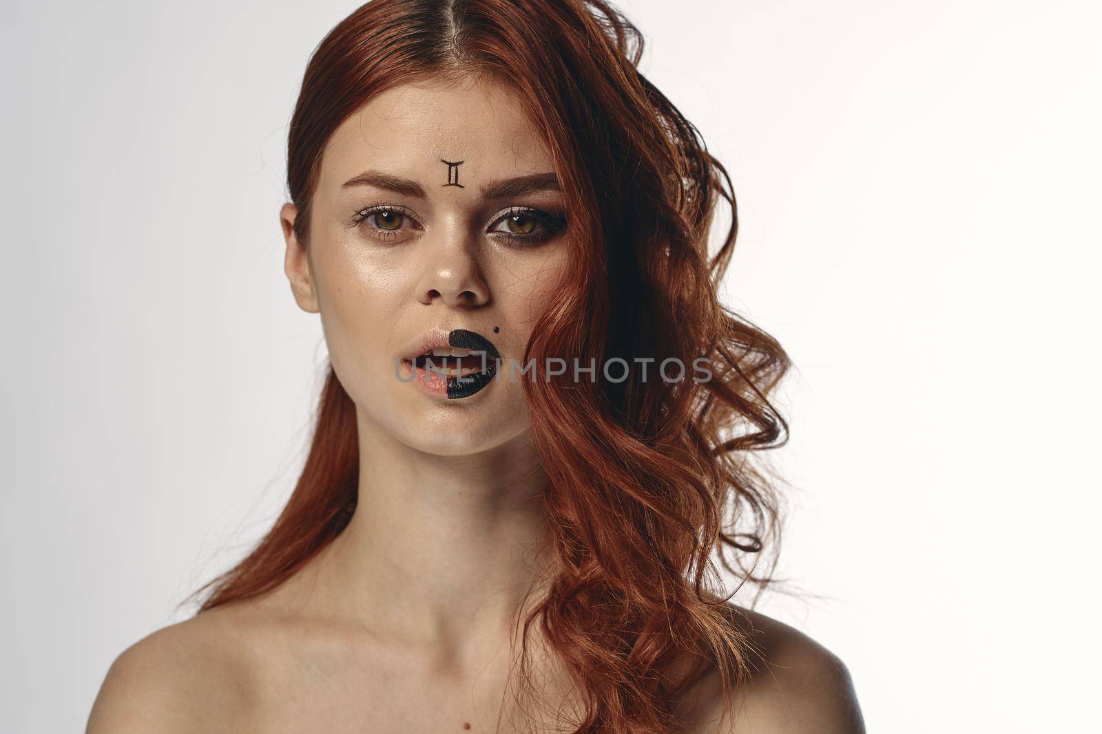 pretty woman with zodiac sign on her face red hair close-up by Vichizh