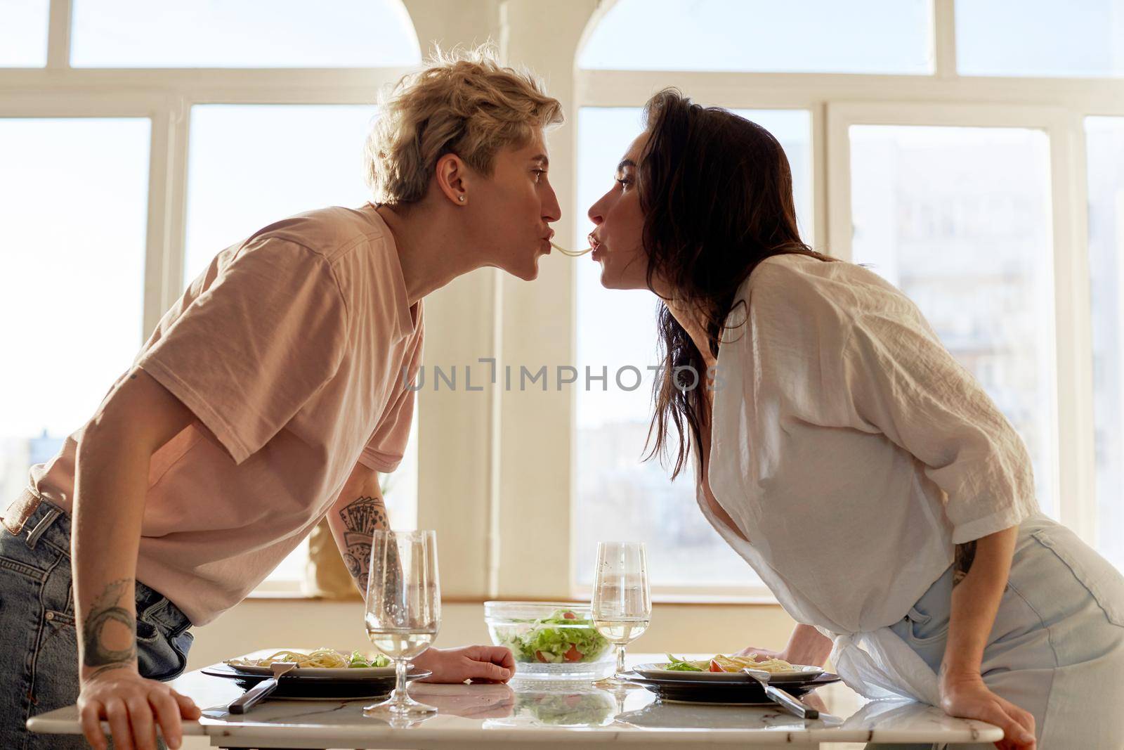 Lesbian couple having fun during romantic dinner by Demkat