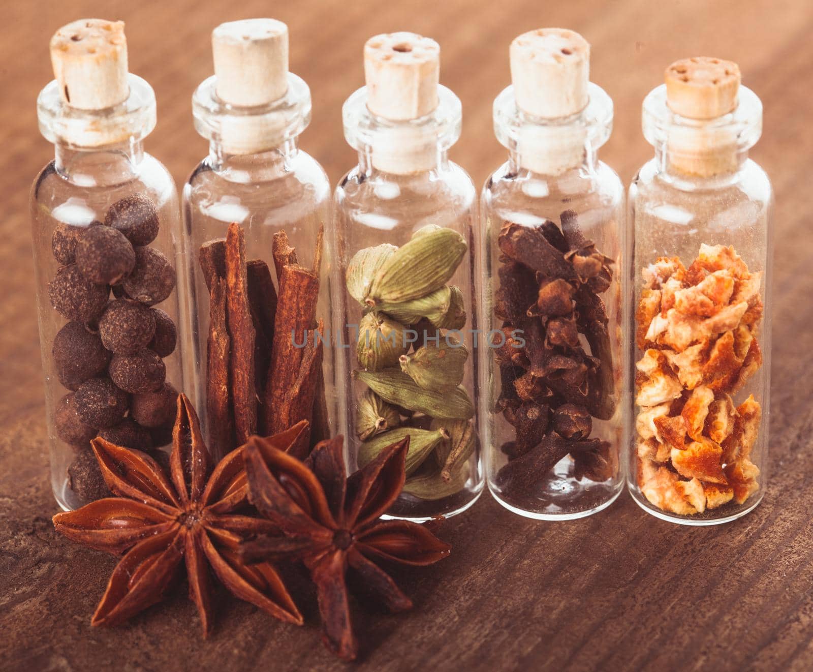 Christmas spices for mulled wine or ginger cookies in small decorative bottles