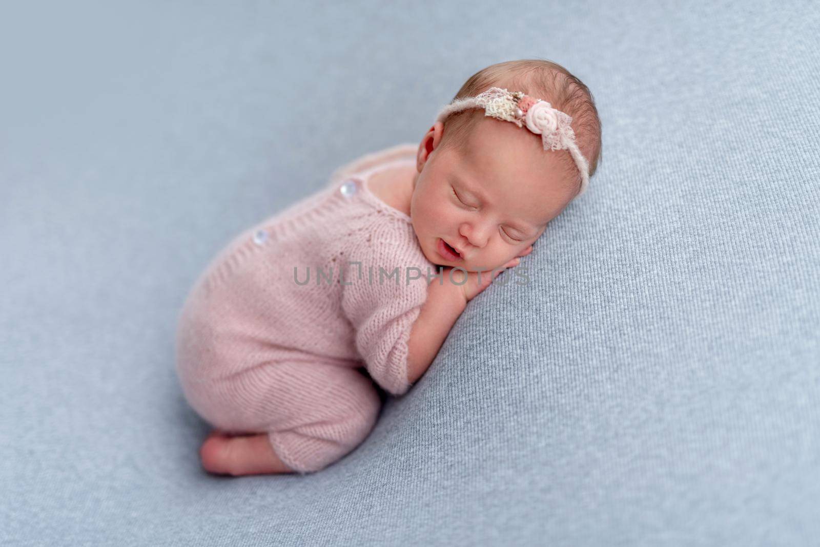 Lovely newborn sleeping comfortable on stomach