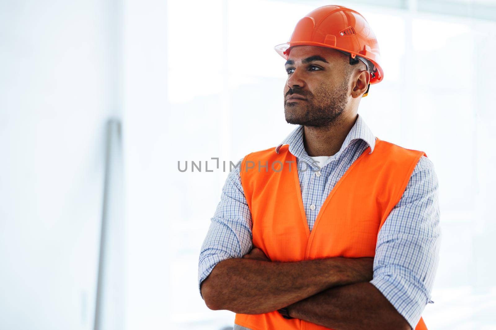 Portrait of young construction engineer wearing hardhat, close up