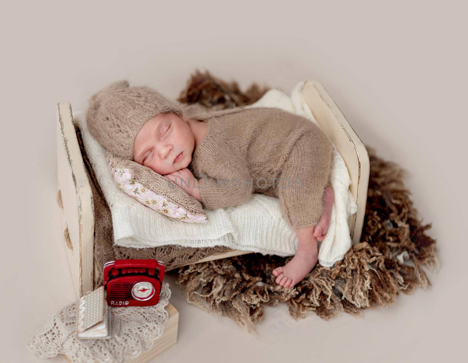 Beautiful newborn sleeping on tiny bed