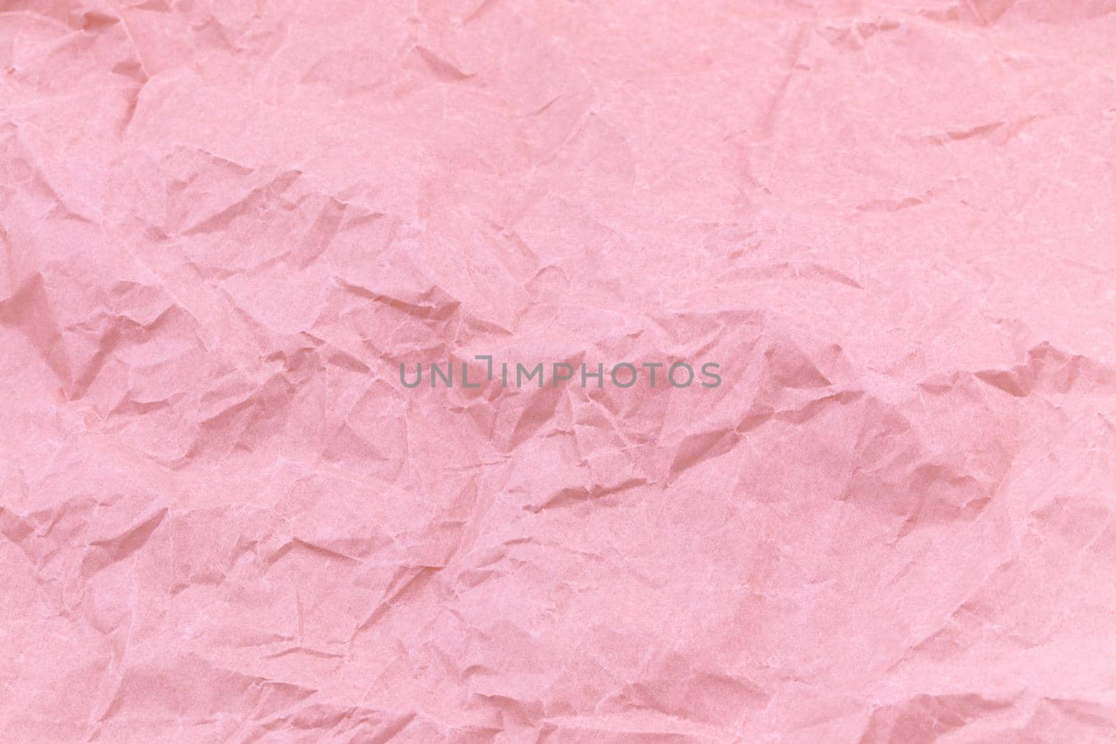 Texture of pink craft crumpled paper background.