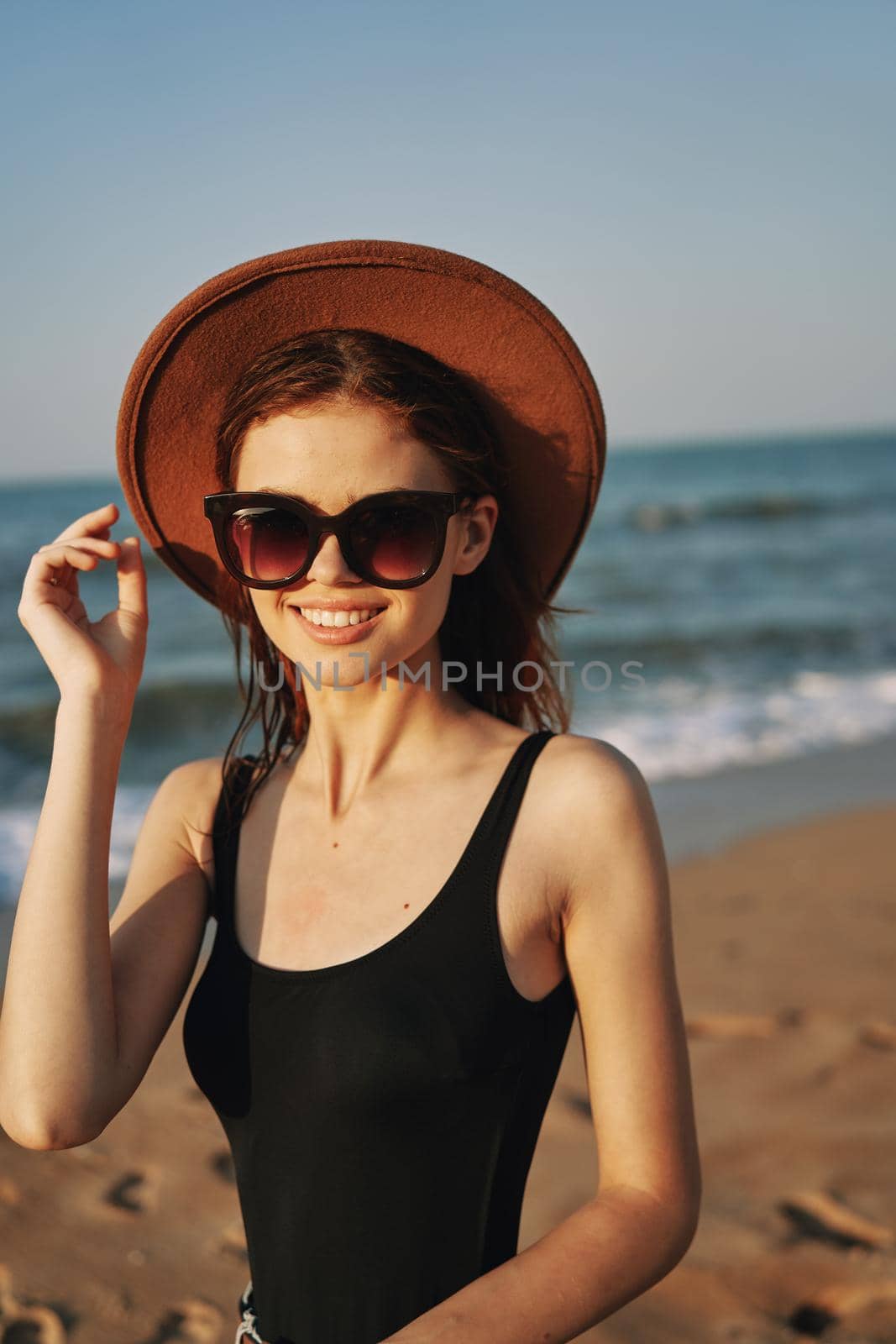 cheerful woman in sunglasses Sandy coast landscape sun by Vichizh