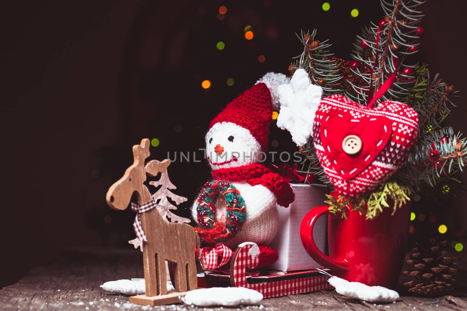 Knitted snowman on the sledges and gift box