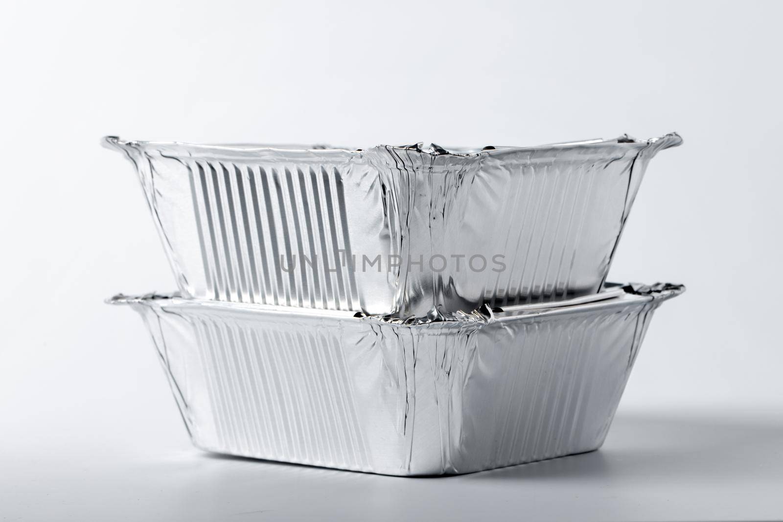 Foil food box with takeaway meal on white background by Fabrikasimf