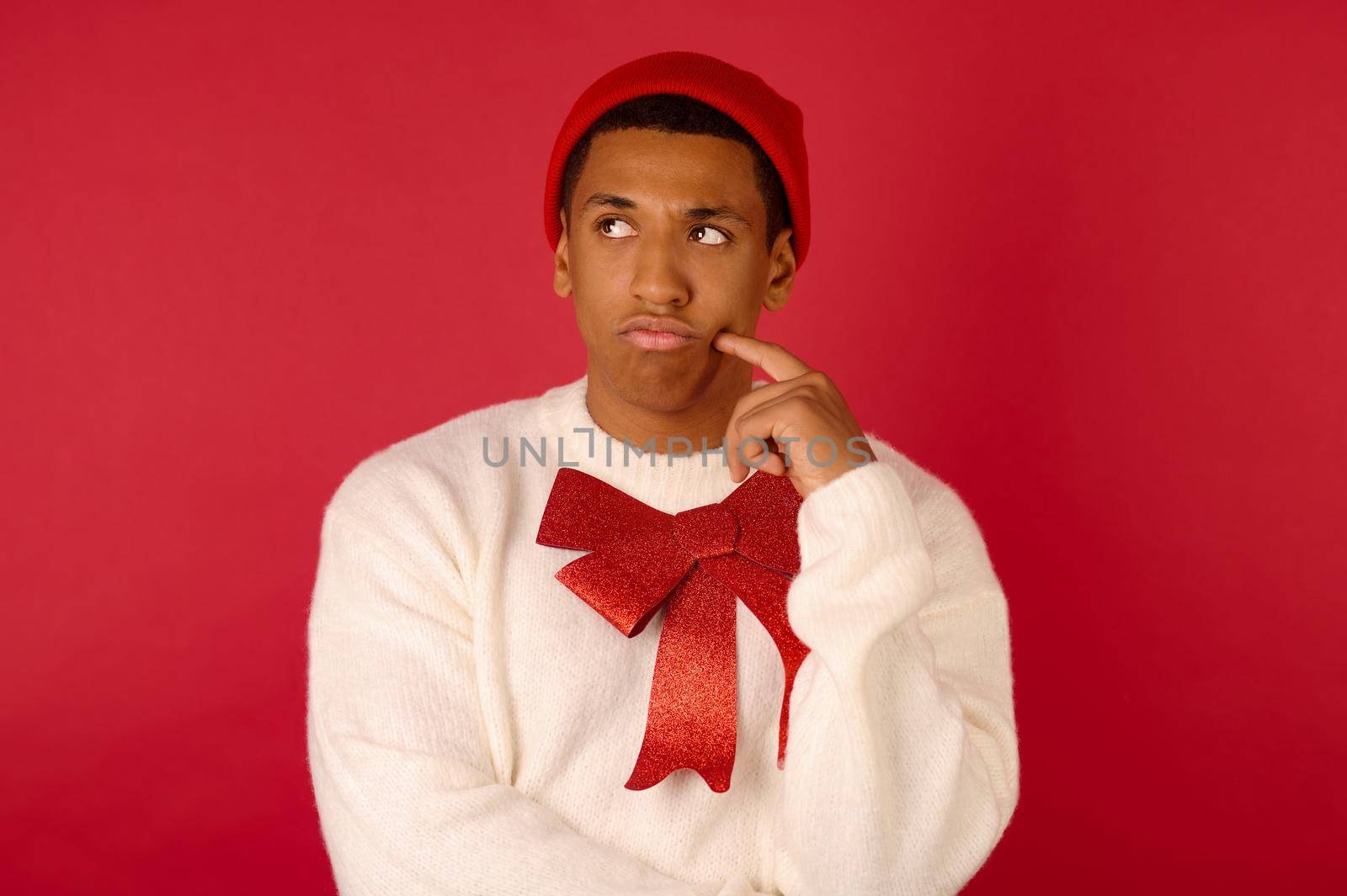 Man on red backgraound. Dark-skinned man with a red ribbon on red background