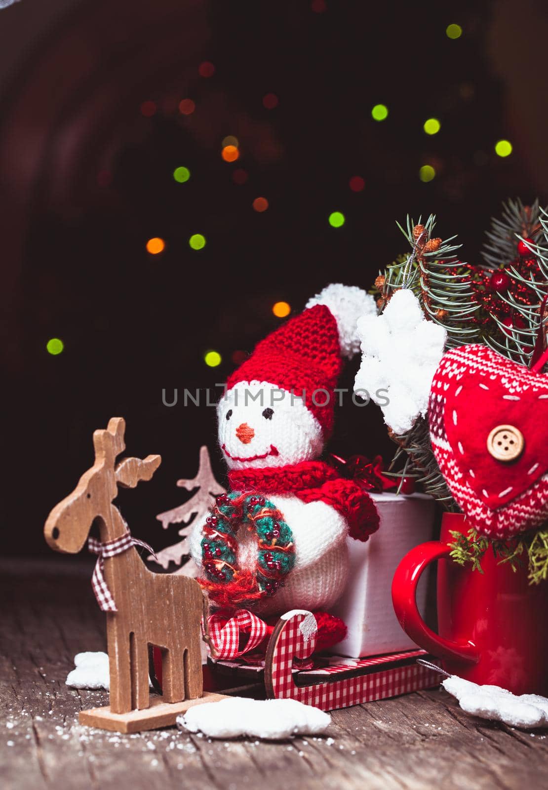 Knitted snowman on the sledges and gift box