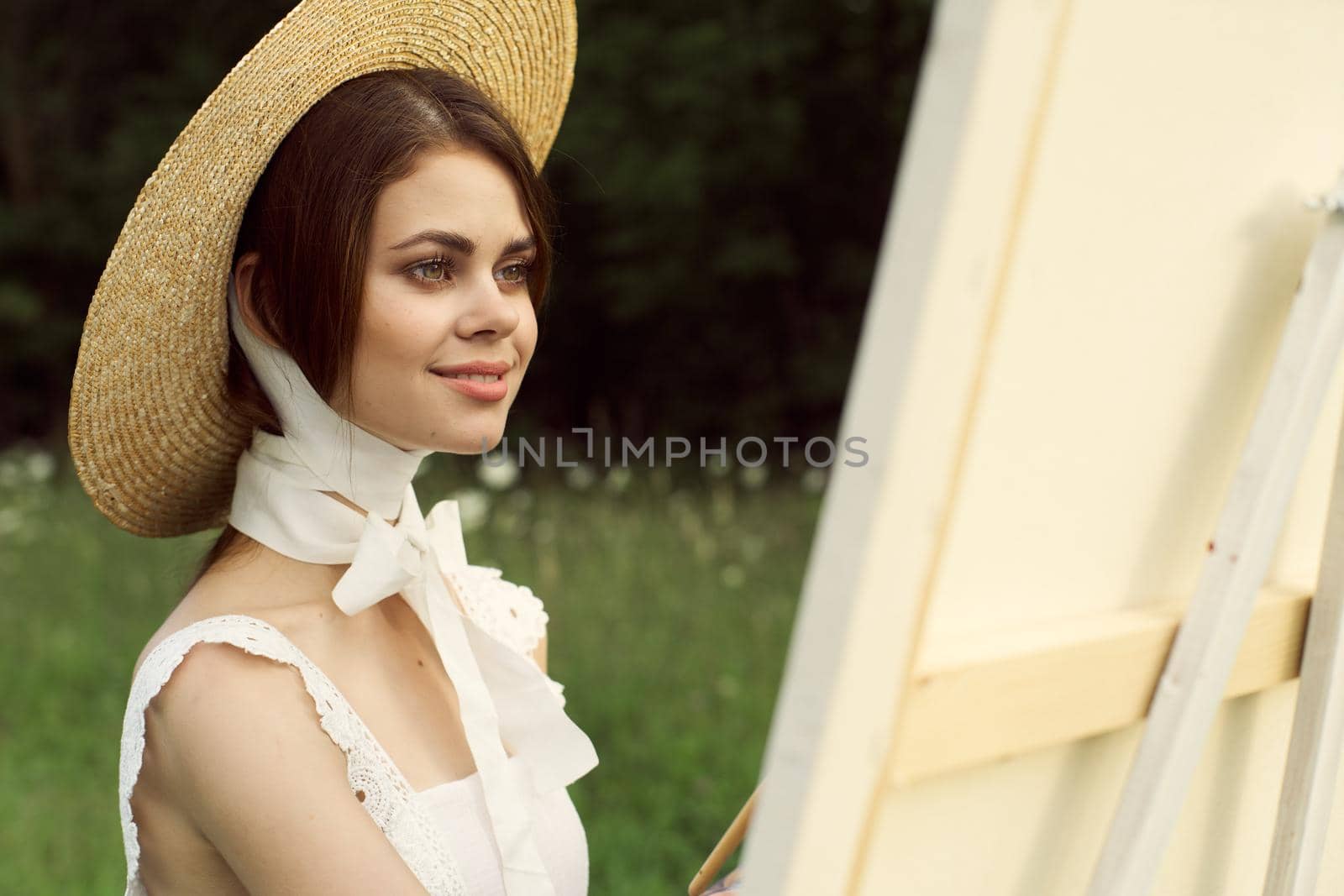 Woman in white dress outdoors artist drawing easel by Vichizh
