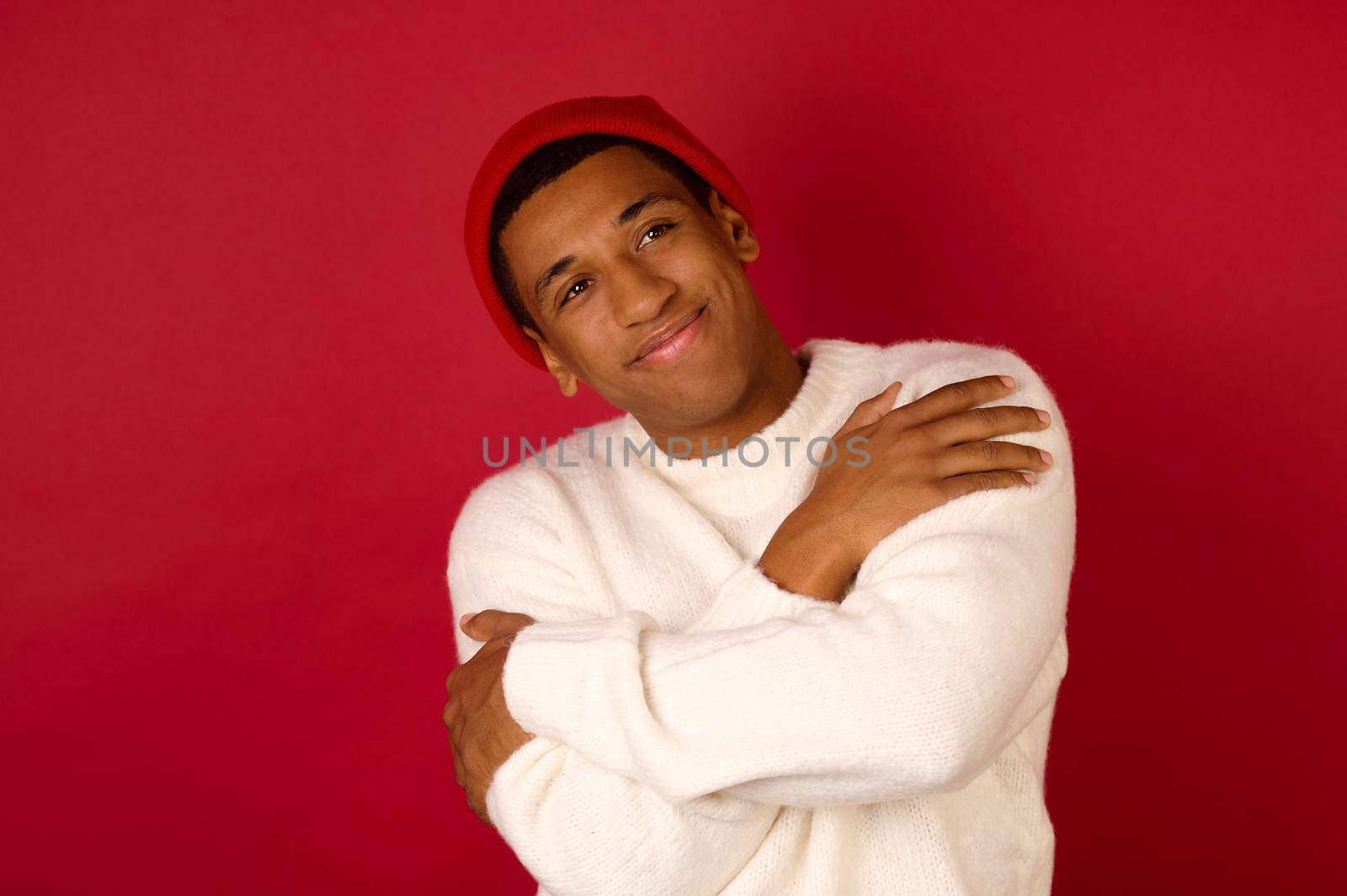 Xmas time. Dark-skinned young man in a santa hat