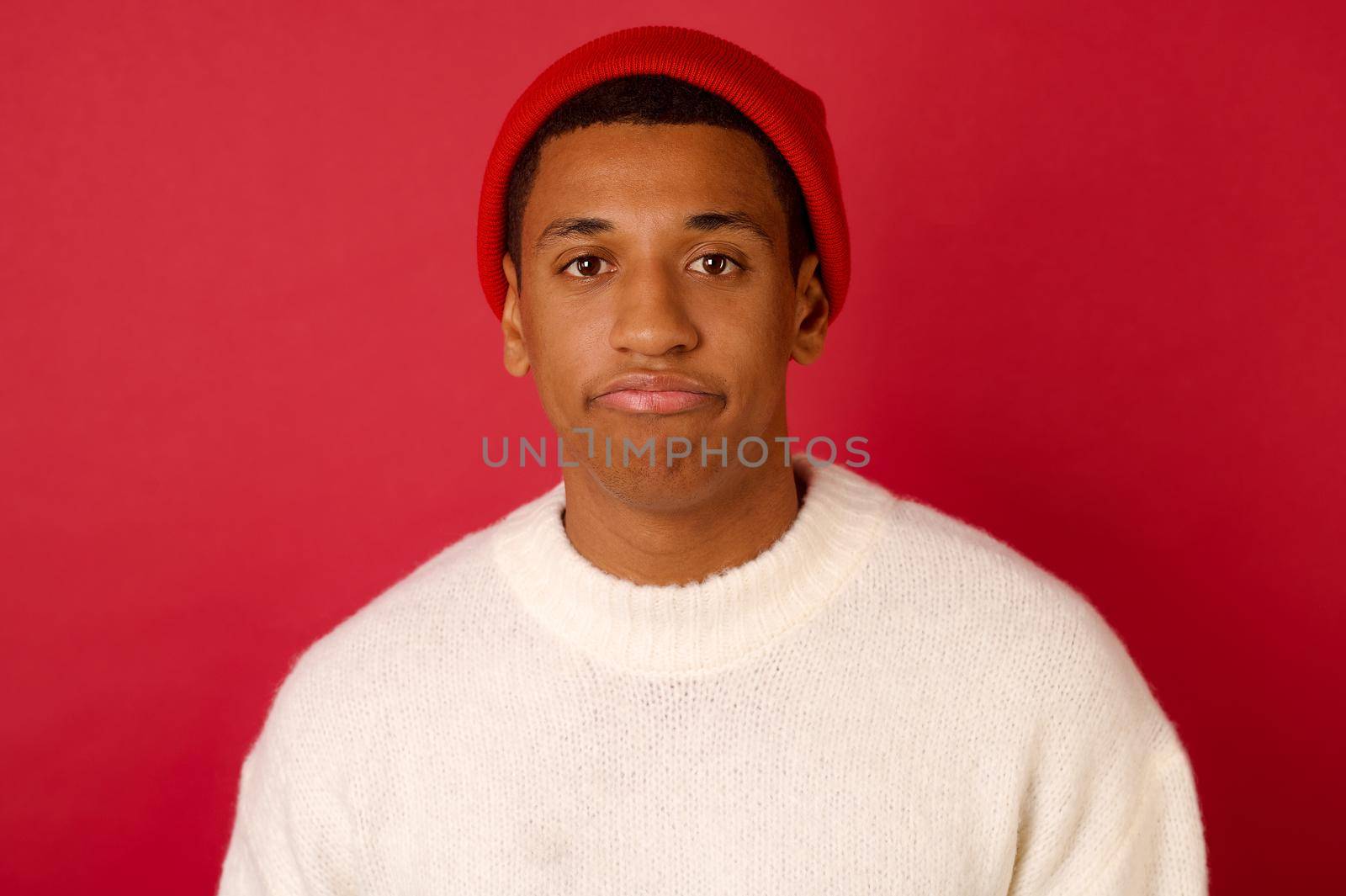 Xmas time. Dark-skinned young man in a santa hat