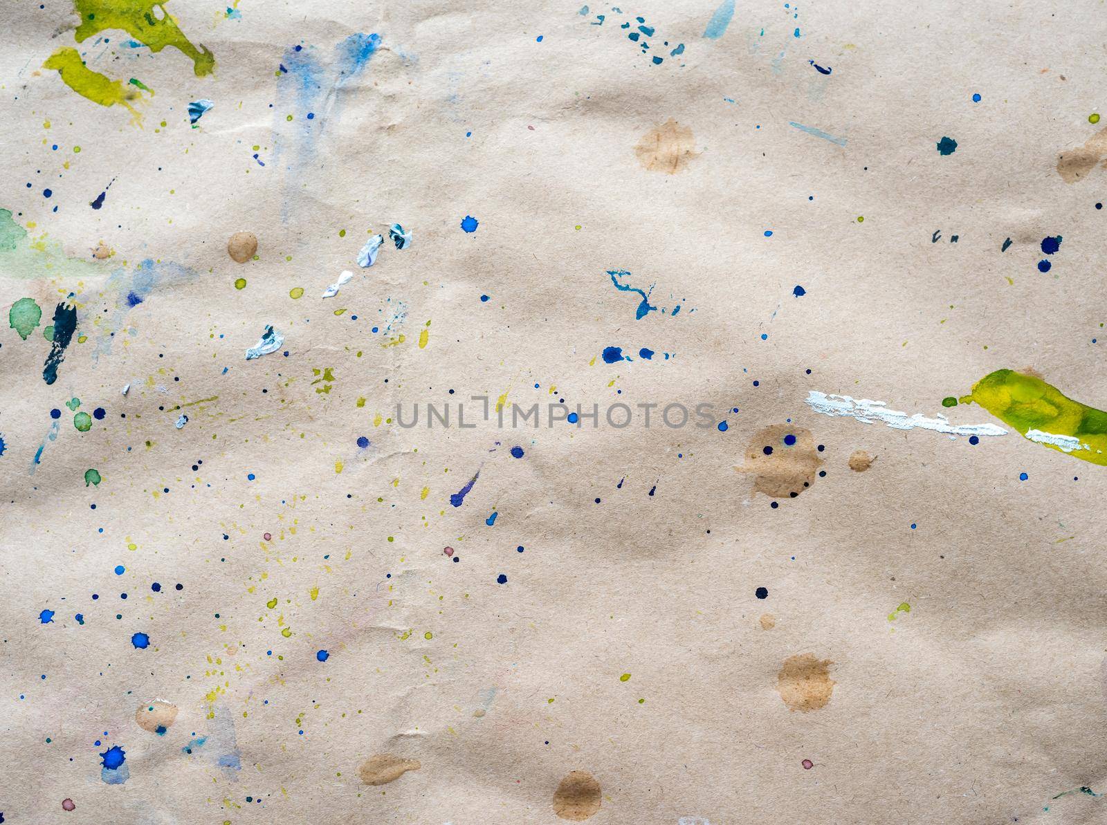 Abstract drawing of strokes and droplets at watercolor paper