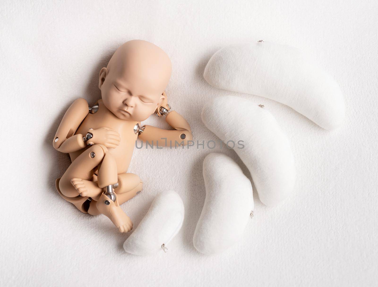 Movable action figure of a newborn kid with bean pillows