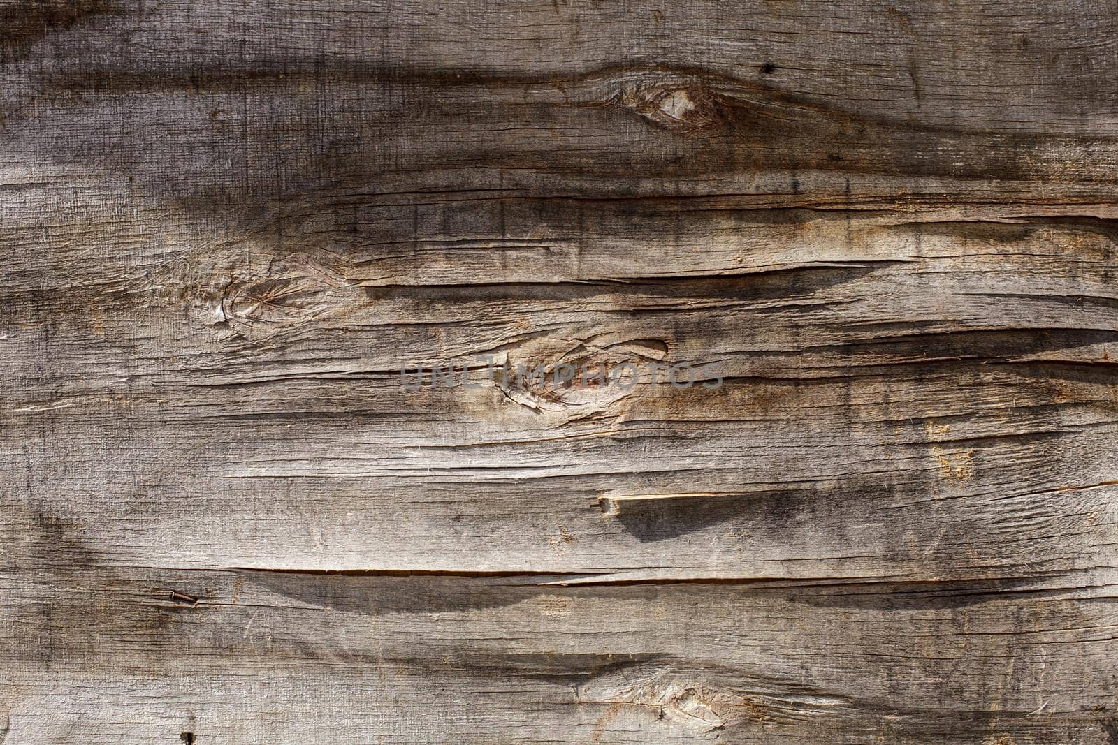 Retro wooden background, cracked plywood wall under the sunshine