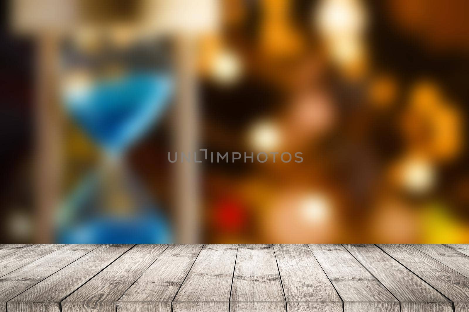 Bokeh background with empty wooden deck table for product montage display.