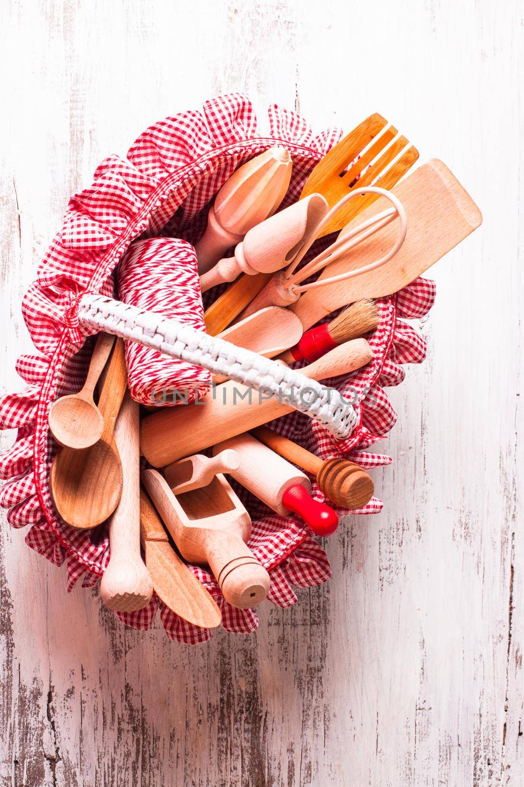 Shabby chic rustic basket with wooden kitchen utensils