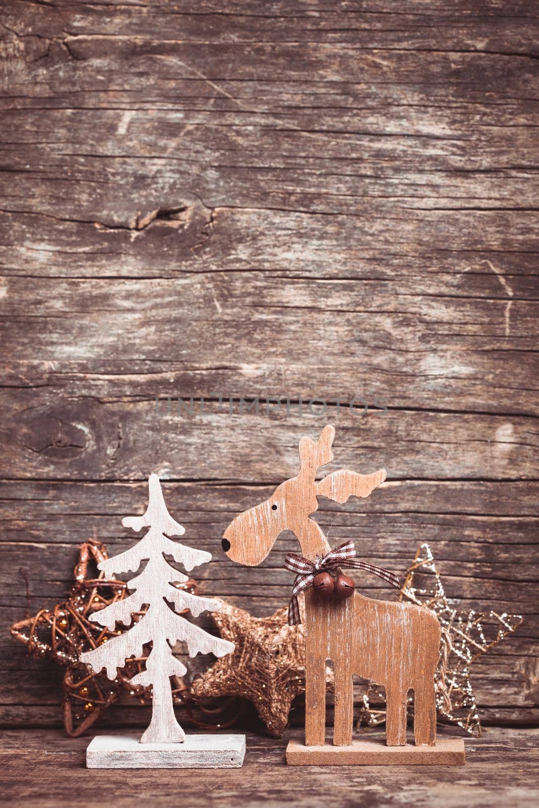 Natural christmas decor - deer and fir tree over wooden background with copy space