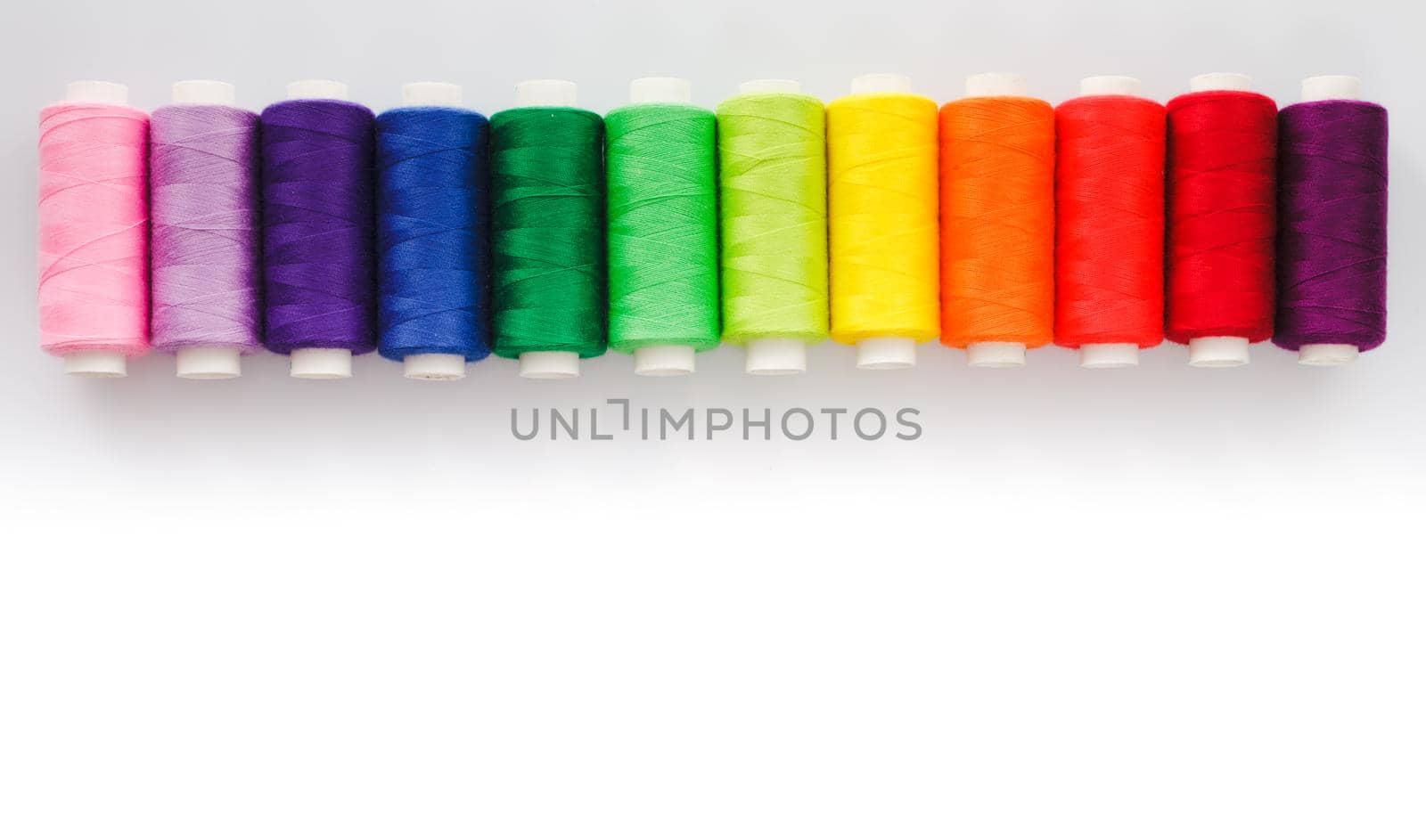 Sewing multicolored threads isolated on a white