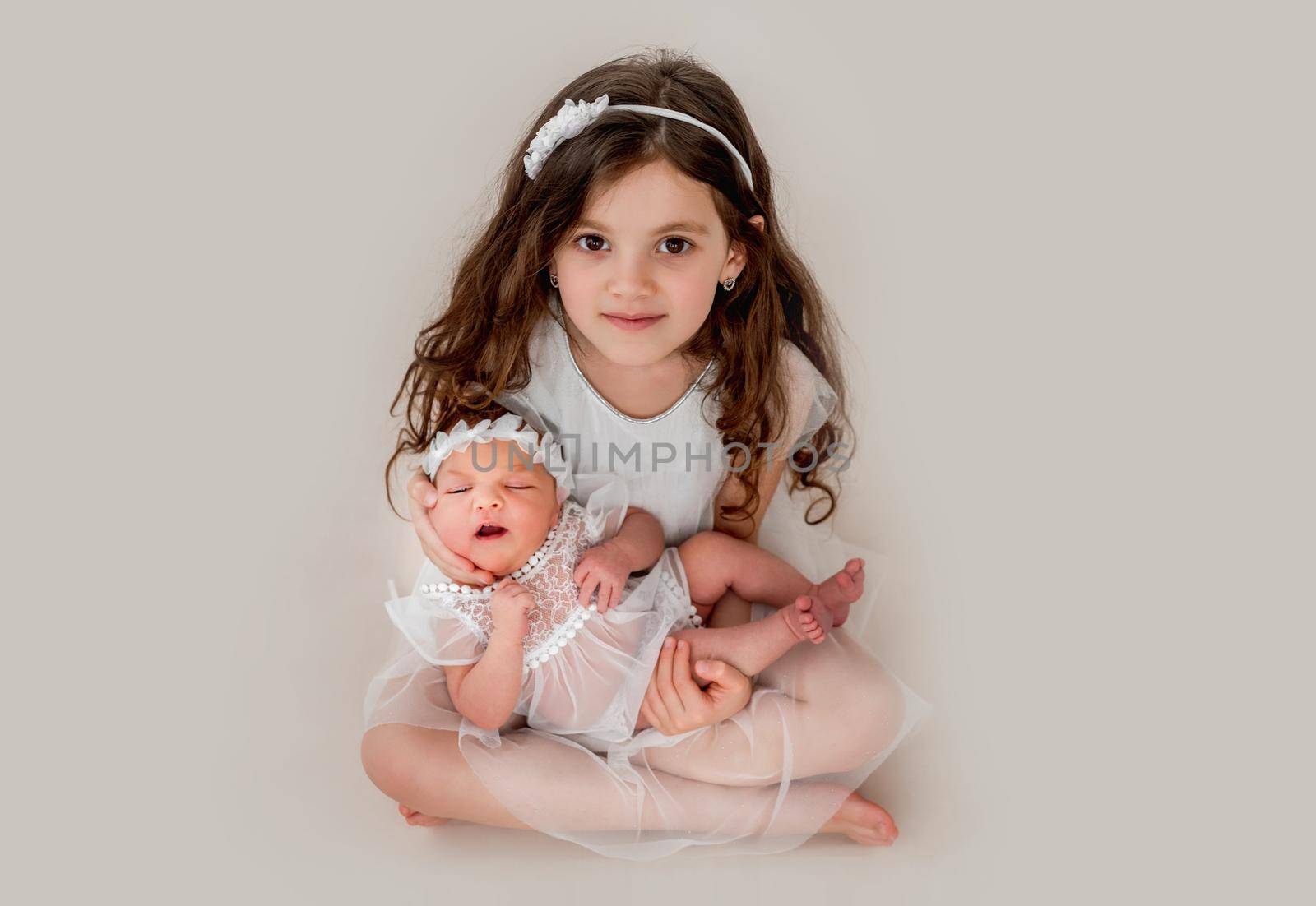 Girl with her newborn sister by tan4ikk1