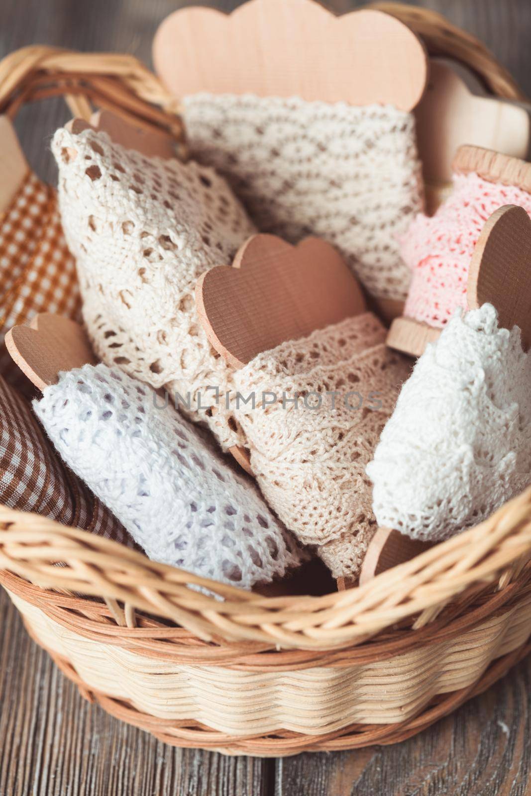 Vintage lace on the wooden bobbin in a basket