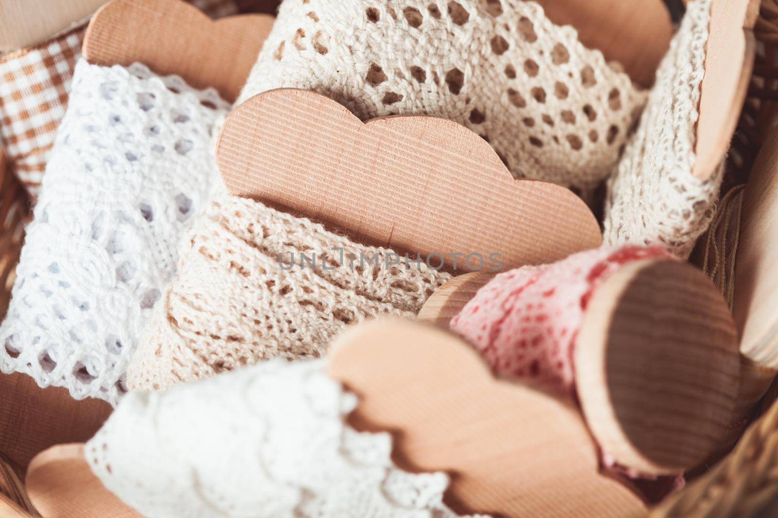 Vintage lace on the wooden bobbin in a basket