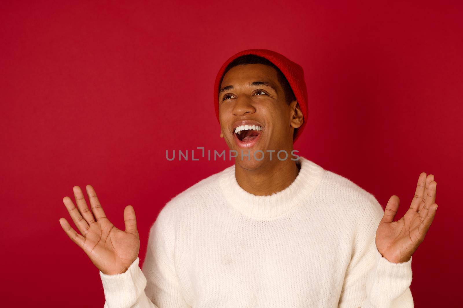 Xmas time. Dark-skinned young man in a santa hat