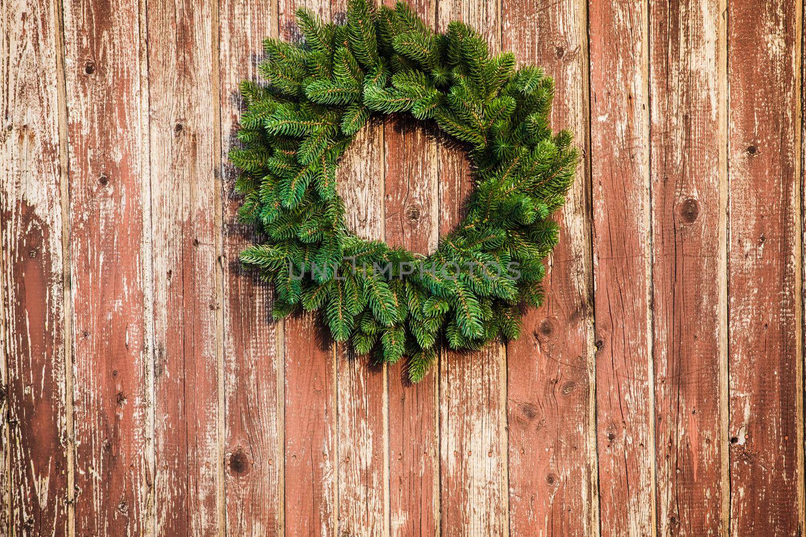 Christmas wreath on the shabby wooden door. Christmas holiday background with copy space