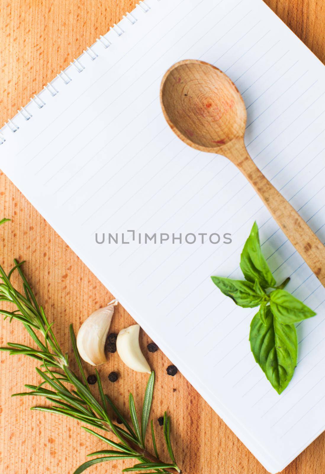 Recipe concept. Blank sheet of paper on a wooden board with spices