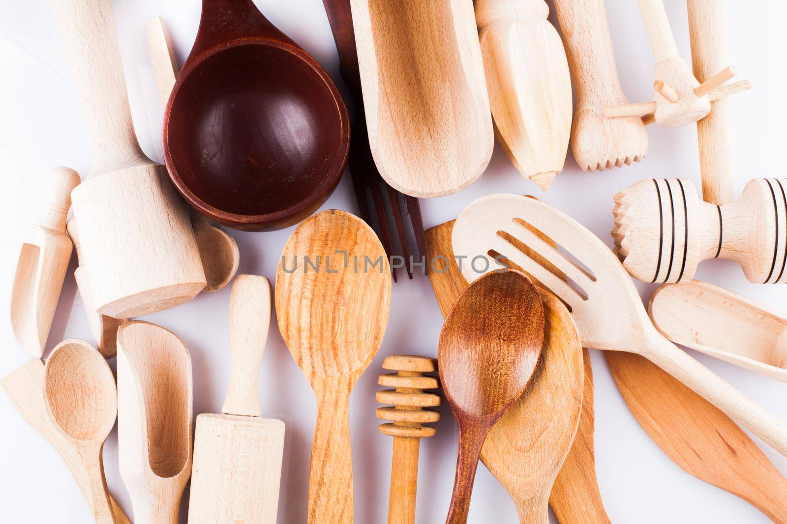 Assortment of wooden kitchen utensils on a white background