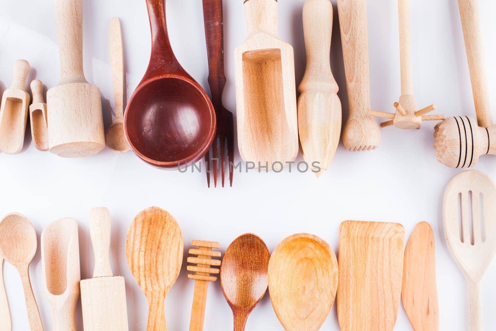 Assortment of wooden kitchen utensils on a white background