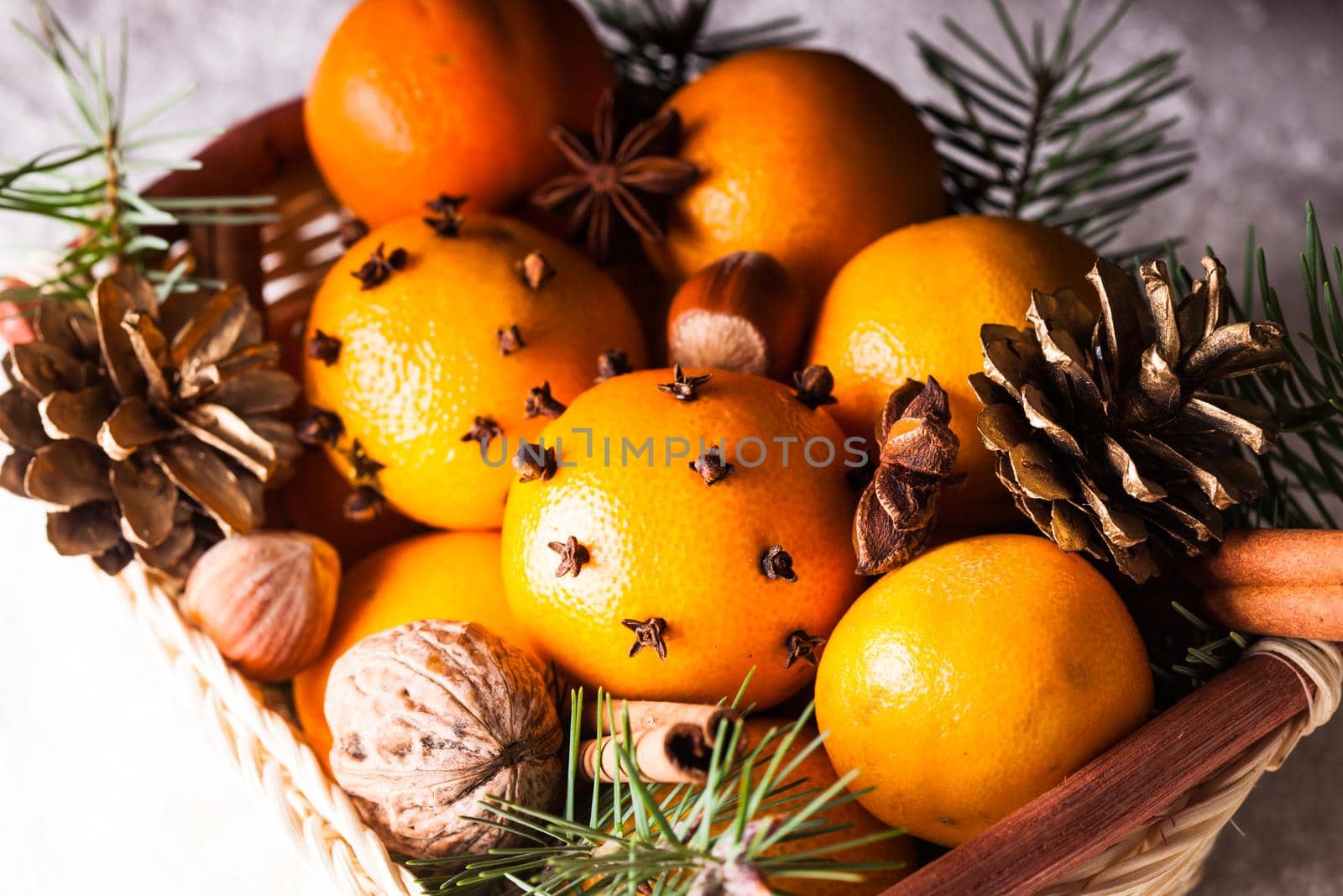 Christmas basket - fir, tangerins and spices on the snow