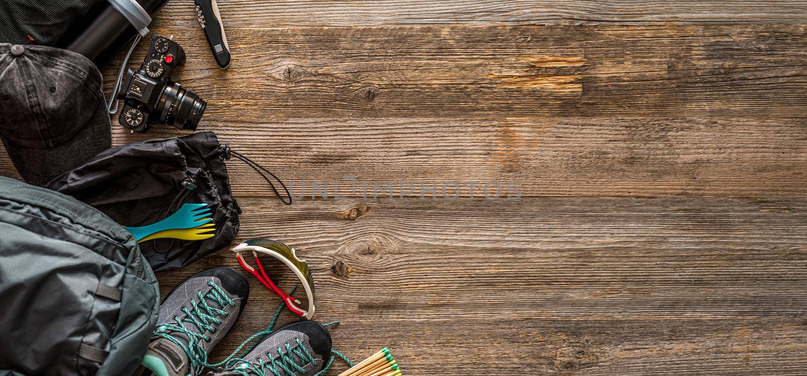 Top view of trekking equipment in corner on wooden background with copy space, top view