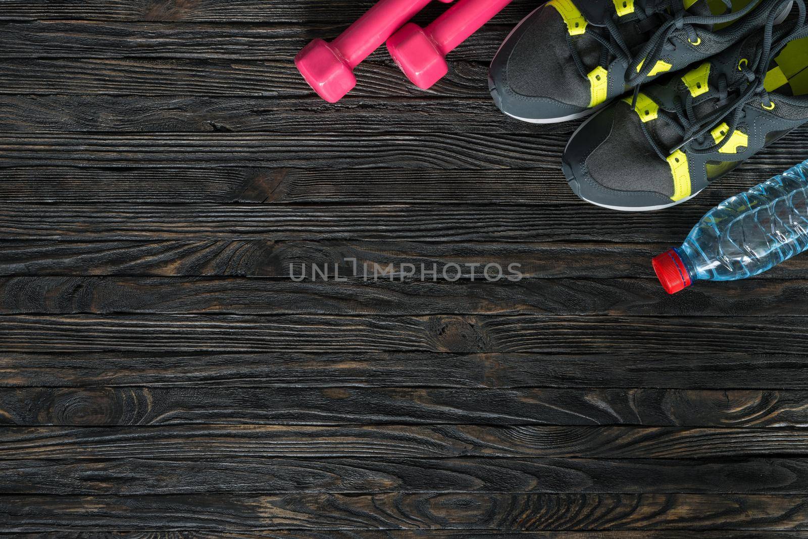 sport fitness items on dark wooden background by tan4ikk1