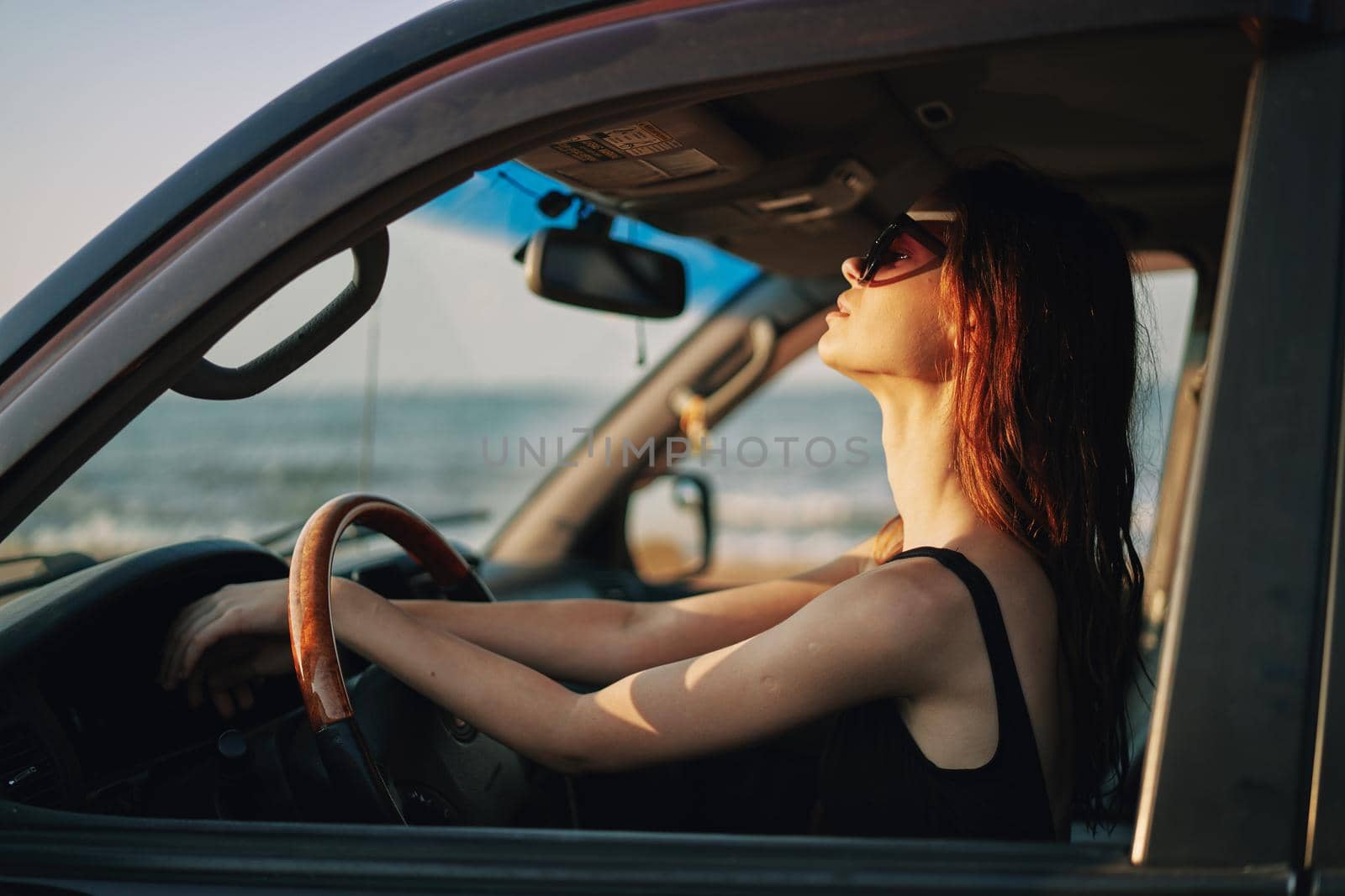 pretty woman in sunglasses driving a car trip. High quality photo