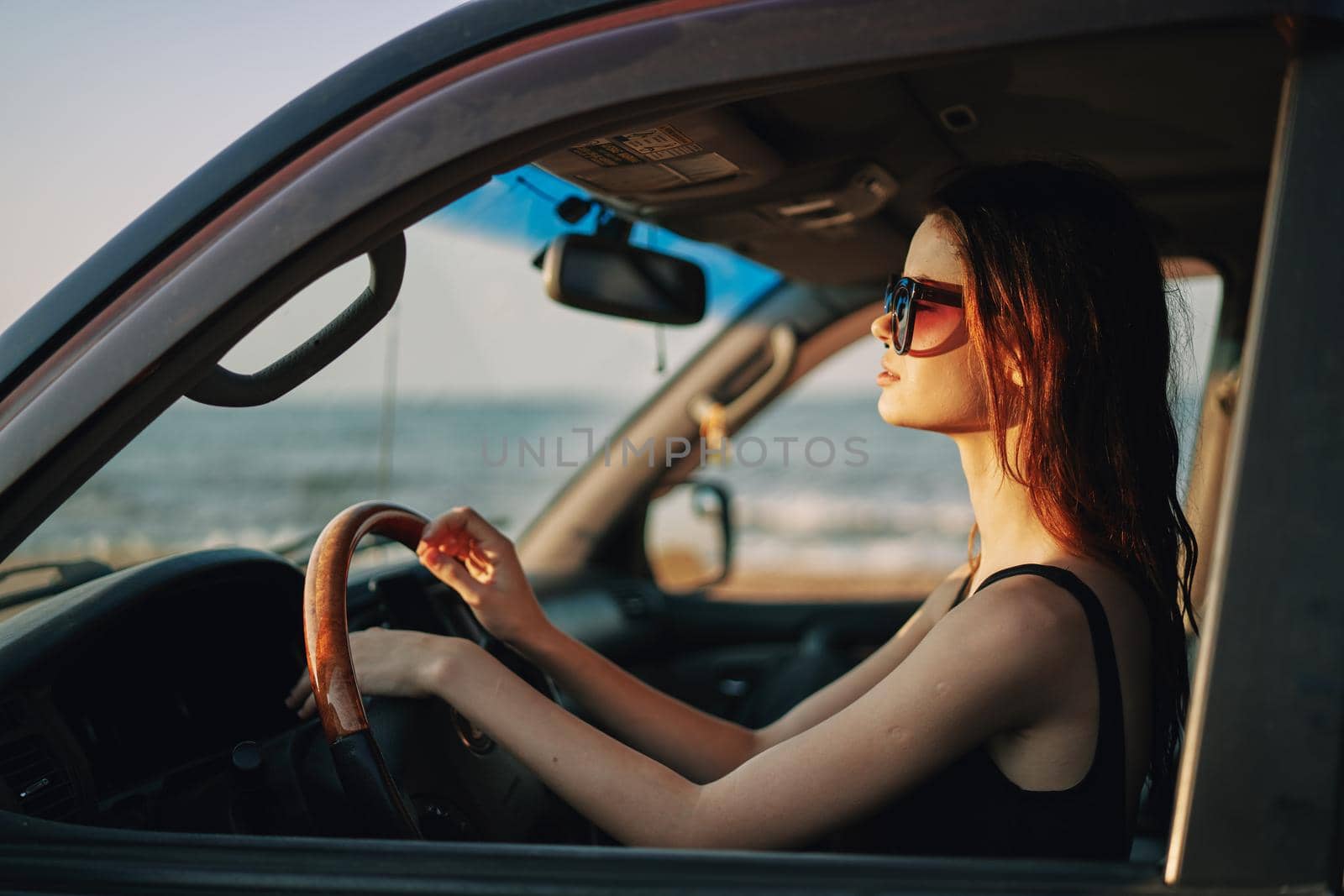 pretty woman in sunglasses driving a car trip by Vichizh