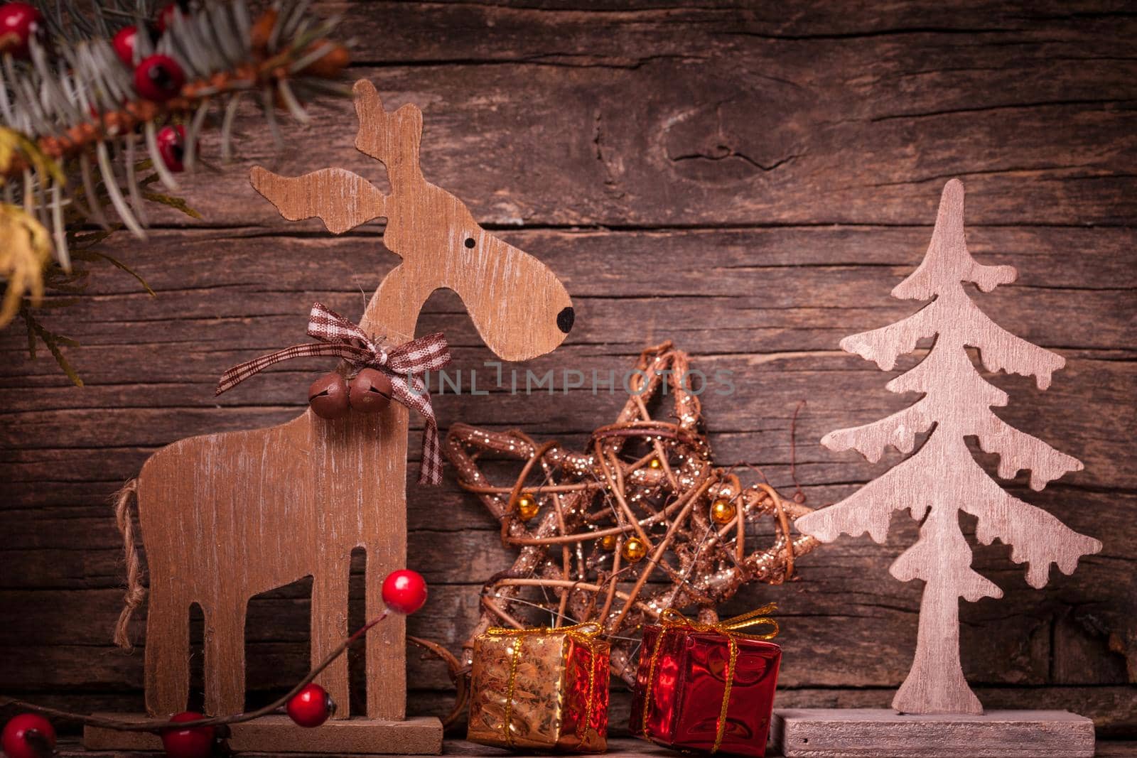 Natural christmas decor - deer and fir tree over wooden background