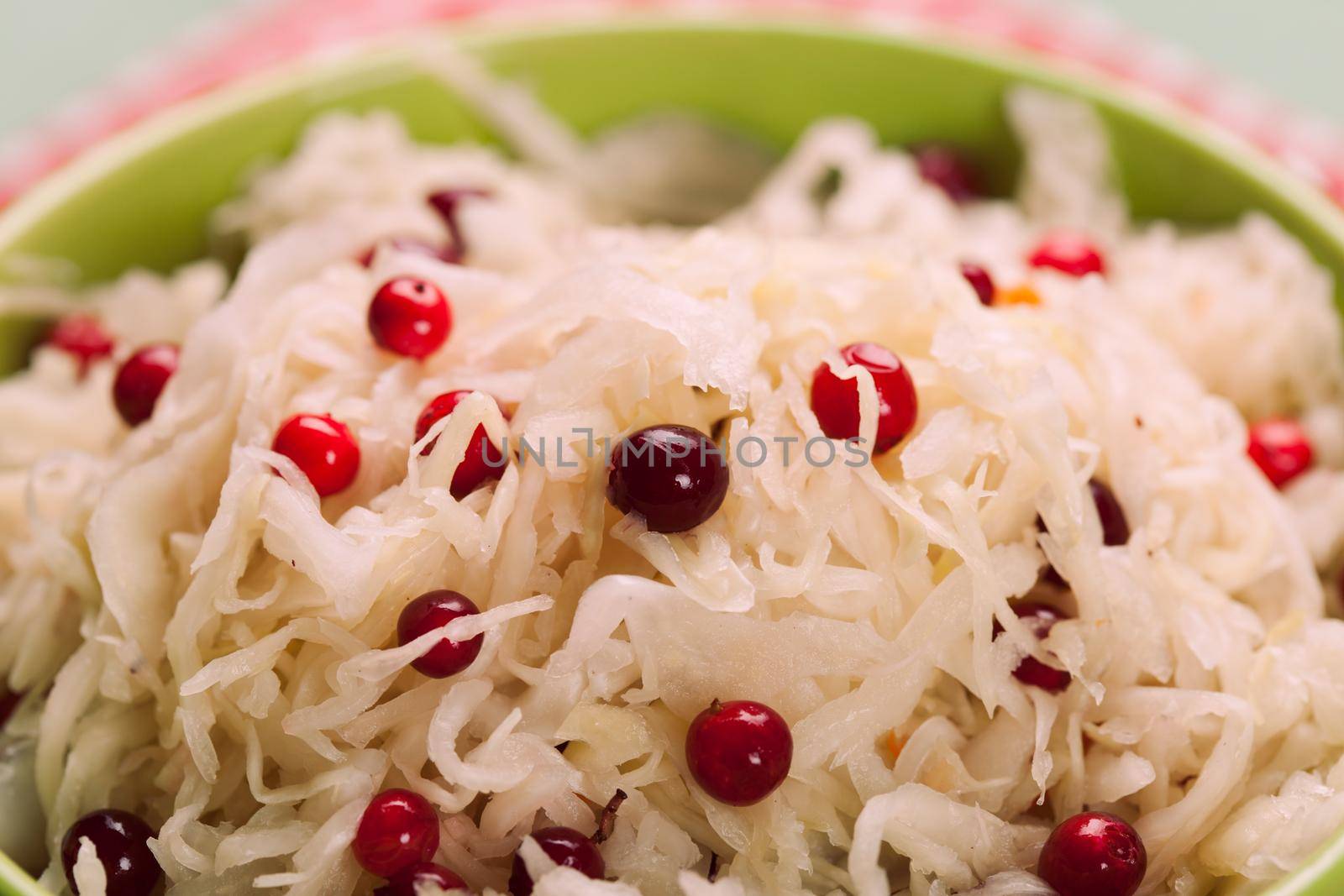 sauerkraut with cranberry in a green bowl